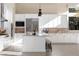 Bright kitchen featuring white cabinets, stainless steel appliances, tile backsplash, a kitchen island, and high ceilings at 11015 Sanctuary Cove Ct, Las Vegas, NV 89135