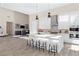 Modern kitchen with white cabinets, stainless steel appliances, and a center island with bar seating, perfect for entertaining at 11015 Sanctuary Cove Ct, Las Vegas, NV 89135
