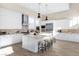 Bright kitchen with white cabinets, a kitchen island, pendant lighting, and stainless steel appliances at 11015 Sanctuary Cove Ct, Las Vegas, NV 89135