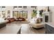 Bright living room showcasing a fireplace, hardwood floors, large windows, and comfortable sectional seating at 11015 Sanctuary Cove Ct, Las Vegas, NV 89135