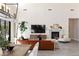 Open-concept living room featuring a modern fireplace, high ceilings, large windows, and comfortable seating at 11015 Sanctuary Cove Ct, Las Vegas, NV 89135