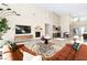 Spacious living room with high ceilings, fireplace, wet bar, a comfortable seating area, and large windows at 11015 Sanctuary Cove Ct, Las Vegas, NV 89135