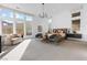 Large main bedroom with plush carpet, seating area, and abundant natural light at 11015 Sanctuary Cove Ct, Las Vegas, NV 89135