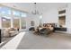 Bright main bedroom with large windows, neutral decor, and sitting area that provides a peaceful and relaxing retreat at 11015 Sanctuary Cove Ct, Las Vegas, NV 89135