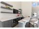 Stylish wet bar area with floating shelves, beverage cooler, gray cabinetry, and sleek countertops at 11015 Sanctuary Cove Ct, Las Vegas, NV 89135