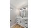 Modern bathroom with white cabinets, quartz countertop, and black accents at 1743 Eddingham Ct, Las Vegas, NV 89156