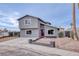 Two-story house with gray exterior, red door, and landscaped yard at 1743 Eddingham Ct, Las Vegas, NV 89156