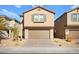 Two-story house with a beige exterior, brown garage door, and landscaped front yard at 1818 Wild Grain Ave, North Las Vegas, NV 89086