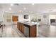 Open concept kitchen with island, stainless steel appliances, and views to living room at 1818 Wild Grain Ave, North Las Vegas, NV 89086