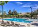 Community pool with lounge chairs and shade structures at 3186 Del Terra Ave, Henderson, NV 89044