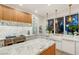 Bright kitchen features marble countertops, white cabinets, and a farmhouse sink at 409 Grand Augusta Ln, Las Vegas, NV 89144