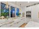 Bright kitchen with white cabinets, marble countertops, and gold fixtures at 409 Grand Augusta Ln, Las Vegas, NV 89144