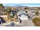 Aerial view of single story home with pool and solar panels, mountain backdrop at 4125 Montemesa Cir, Las Vegas, NV 89108