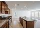 Open concept kitchen with island and stainless steel appliances at 4143 Juniper Pear Ave, Las Vegas, NV 89141