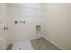 Bright laundry room with built-in shelving and a drain at 4143 Juniper Pear Ave, Las Vegas, NV 89141