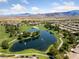 Aerial view showing a golf course, lake, and surrounding houses at 4430 Deliza Ln, Pahrump, NV 89061