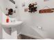 Small powder room with pedestal sink and beachy decor at 4430 Deliza Ln, Pahrump, NV 89061