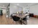 Dining area with a large wooden table and black chairs, near entryway at 4430 Deliza Ln, Pahrump, NV 89061