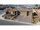 Single-story home with two-car garage, landscaped front yard, and brick driveway at 4430 Deliza Ln, Pahrump, NV 89061