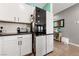 Modern kitchen with white cabinets and a stainless steel refrigerator at 4430 Deliza Ln, Pahrump, NV 89061