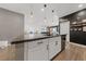 Kitchen island with white cabinets and quartz countertops at 4430 Deliza Ln, Pahrump, NV 89061