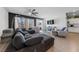 Open-concept living room and kitchen with hardwood floors, gray sectional, and TV at 4430 Deliza Ln, Pahrump, NV 89061