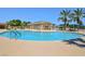 Inviting community pool with a curved design and palm trees at 4430 Deliza Ln, Pahrump, NV 89061