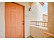 Orange front door with a small balcony at 4655 Gold Dust Ave # 210, Las Vegas, NV 89120
