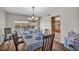 Bright dining room features a spacious table and chairs, chandelier, and hardwood floors at 5017 Wright View Dr, Las Vegas, NV 89120