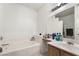 Bathroom with a bathtub, double vanity and mirror at 5655 E Sahara Ave # 2064, Las Vegas, NV 89142