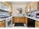 L-shaped kitchen with light wood cabinets and appliances at 5655 E Sahara Ave # 2064, Las Vegas, NV 89142