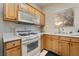 L-shaped kitchen with light wood cabinets and appliances at 5655 E Sahara Ave # 2064, Las Vegas, NV 89142