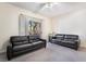 Living room with two leather couches and access to a patio at 5655 E Sahara Ave # 2064, Las Vegas, NV 89142