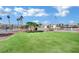 Well-manicured common area with green grass, trees, and a flagpole enhancing the neighborhood's appeal at 6345 Dan Blocker Ave # 101, Henderson, NV 89011