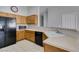 Kitchen offers ample counter space, wood cabinets, and black appliances at 6345 Dan Blocker Ave # 101, Henderson, NV 89011