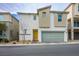 Modern two-story home with a welcoming yellow door and an attached two-car garage at 6935 Magenta Moon St, North Las Vegas, NV 89086