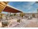 Spacious backyard with a covered patio, fire pit, and outdoor seating at 750 Willow Ave, Henderson, NV 89002