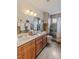 Bright bathroom featuring a tiled shower and stylish vanity with dual sinks at 750 Willow Ave, Henderson, NV 89002