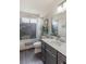 Elegant bathroom with a tiled shower and stylish vanity with dual sinks at 750 Willow Ave, Henderson, NV 89002