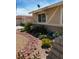 Charming home exterior with well-manicured landscaping, featuring colorful flowers and varied plant life along the foundation at 750 Willow Ave, Henderson, NV 89002