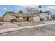 Single story home with a large front yard and mature tree at 750 Willow Ave, Henderson, NV 89002