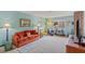 Bright living room featuring a comfortable orange sofa and neutral decor at 750 Willow Ave, Henderson, NV 89002
