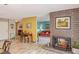 Open living room with a brick fireplace and views into other colorful rooms at 750 Willow Ave, Henderson, NV 89002