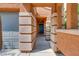 Covered entryway with terracotta tile flooring and dark teal door at 8058 Torremolinos Ave, Las Vegas, NV 89178