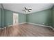 Spacious bedroom featuring wood-look flooring and ceiling fan at 8644 Shady Pines Dr, Las Vegas, NV 89143