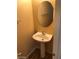 Small bathroom with pedestal sink and oval mirror at 8708 Gateway Glen Dr, Las Vegas, NV 89178