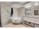 Elegant bathroom with a soaking tub, shower, and double vanity at 9132 Baysinger Dr, Las Vegas, NV 89129