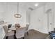 Bright dining area with a four-person table and modern chandelier at 9321 Straw Hays St # 101, Las Vegas, NV 89178