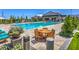 Community pool with lounge chairs, tables, and a clubhouse at 9636 Wildflower Vista Ave, Las Vegas, NV 89166