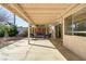 Covered back patio with an outdoor seating area and sliding glass door to the house at 9905 Barrier Reef Dr, Las Vegas, NV 89117